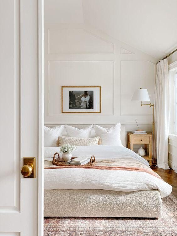 A luxurious bedroom with white curtains, beautifully decorated, with a white bed and natural white linen bedding