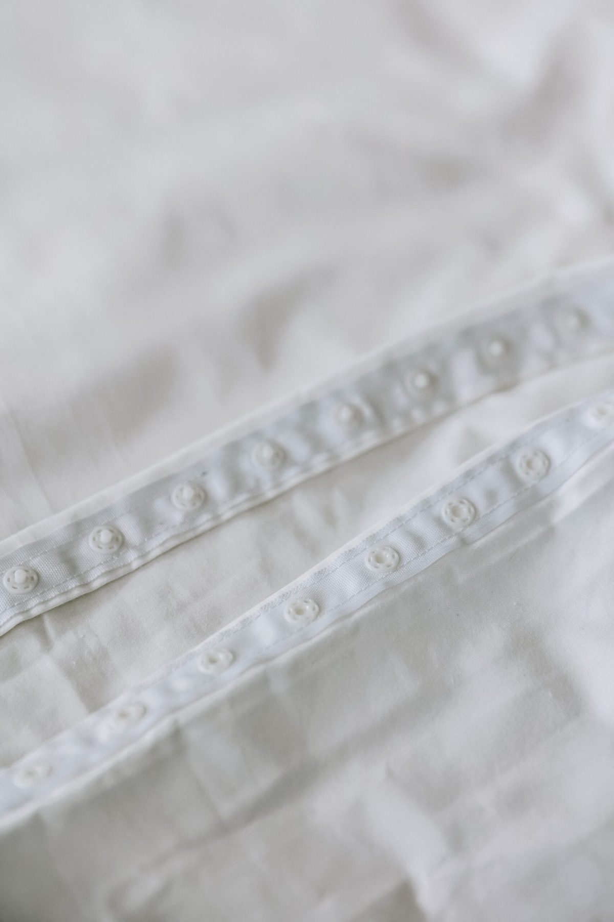 The closure of white damask cotton bed linen