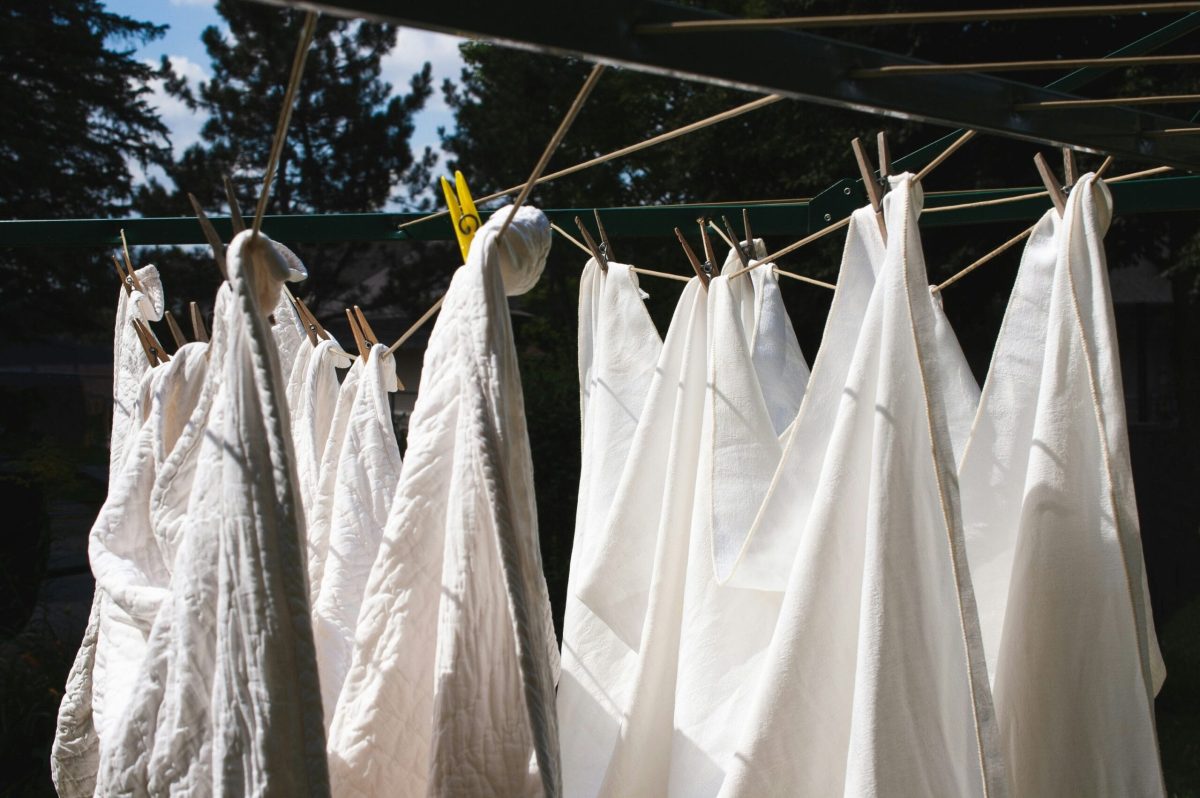 White cotton bed linen hung out to dry